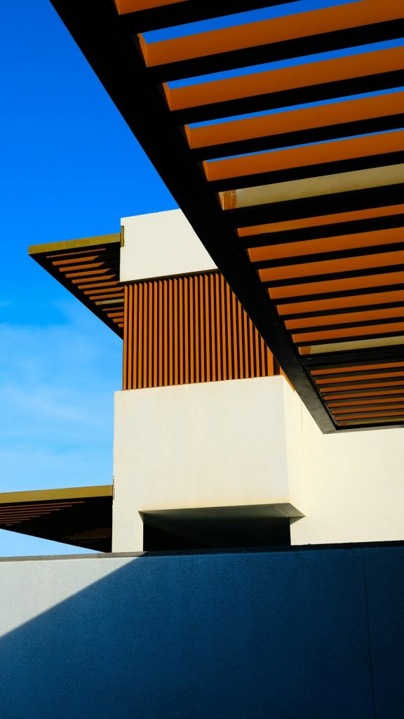 a-white-building-with-a-wooden-roof-and-a-blue-sky-h446hampu7u Alma resort
